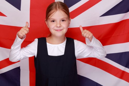 Adorable,little,girl,with,a,sweet,smile,in,school,uniform